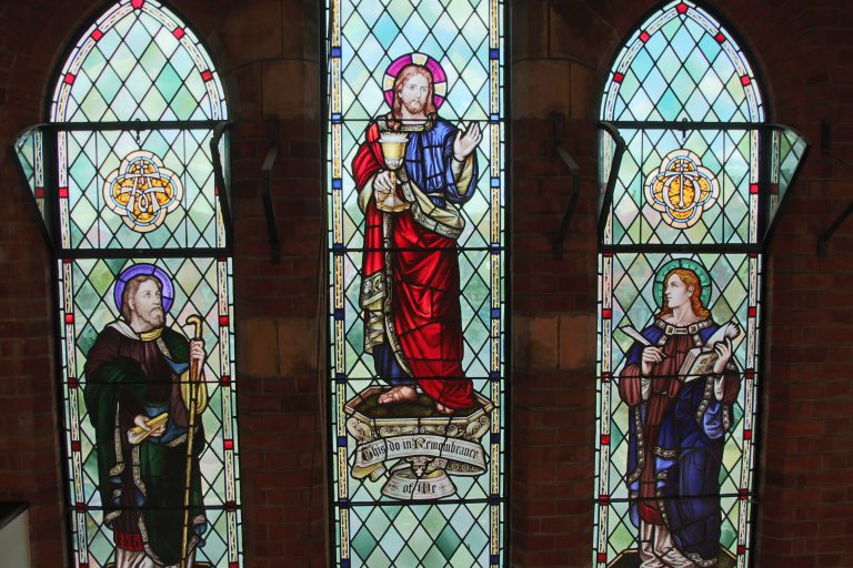 stained-glass-of-jesus-with-st-paul-and-st-john-above-entrance